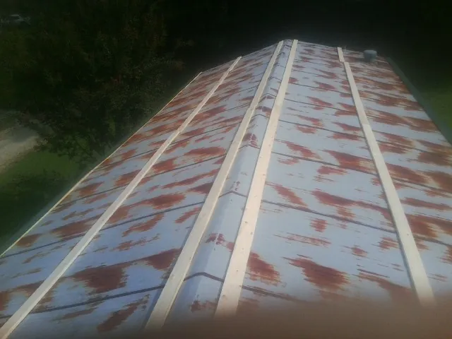 Rusted metal roof panels with new wood purlins before replacement — Storm Damage Roof Repair in Oakley by Roofing Brothers